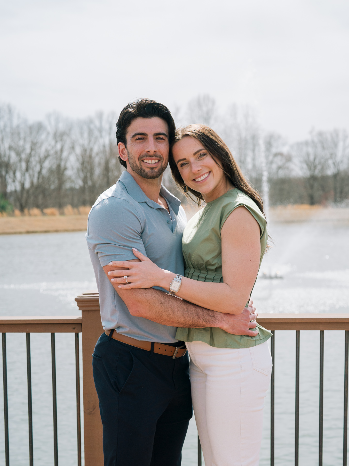 A beautiful couple embraces and smiles at the camera after getting engaged at Montaluce Winery
