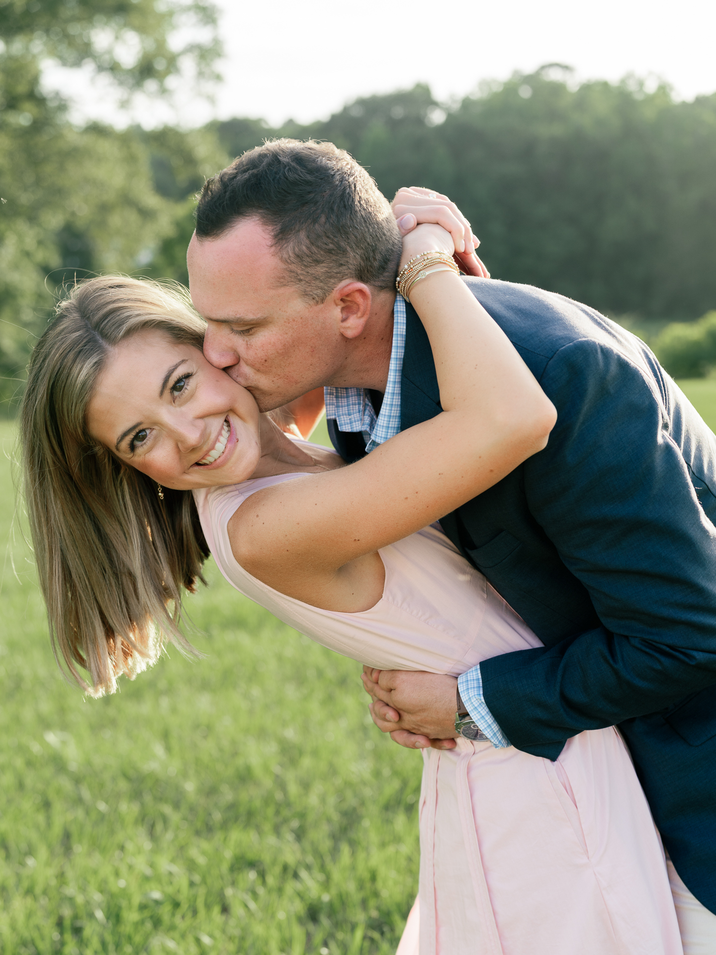 couple embracing golden hour engagement session Rockhouse Farms Auburn Alabama